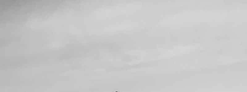 Silhouette of a person doing balance exercises against window